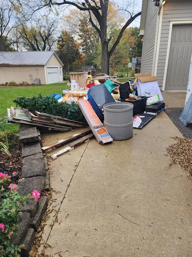 Dumpster being loaded with debris for 12 Yard Dumpster Rental in Lewisville